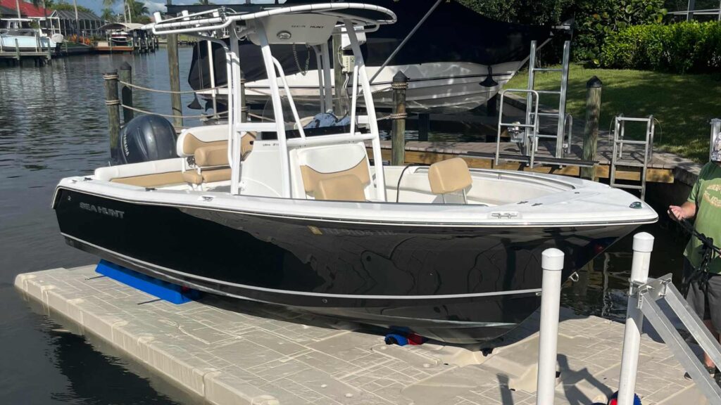 Sea Hunt center console boat on a Wave Armor boat port in a residential canal