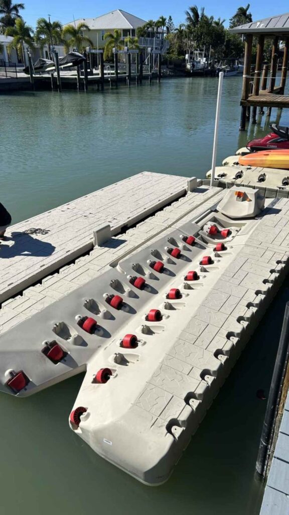 Wave Armor boat port with red rollers being installed in a residential canal