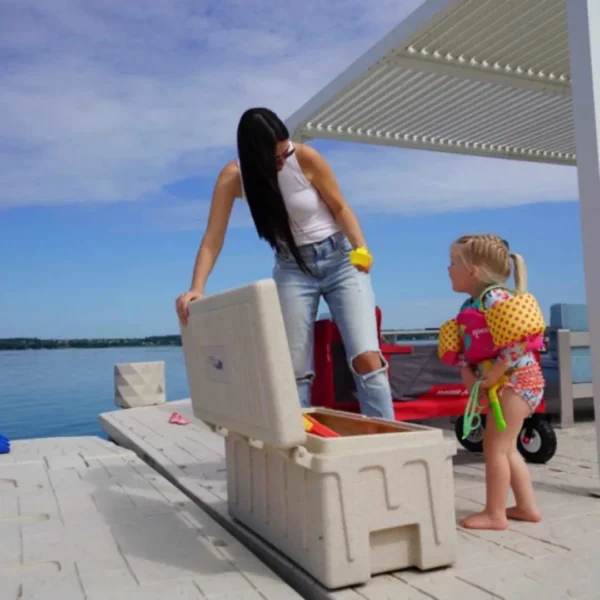 Mother and child using Wave Armor Lockable Dock Box on waterfront dock