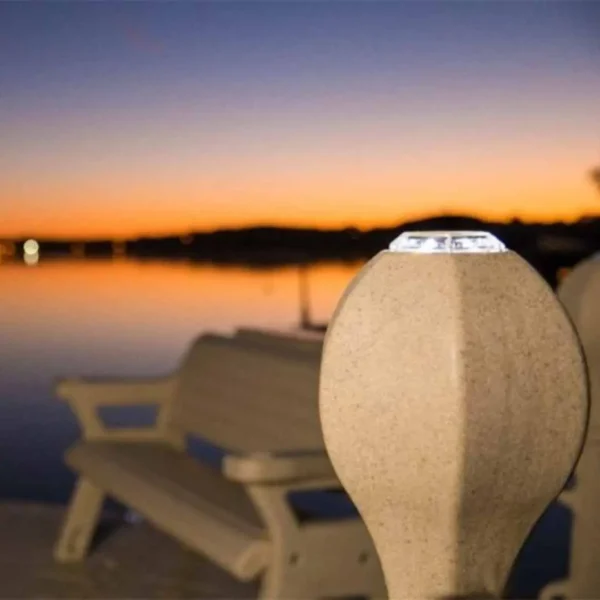 Close-up of solar dock light mounted on Heritage Post Cover at sunset