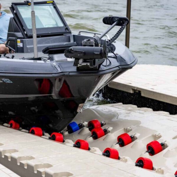Boat docking onto Wave Armor Pro 8 Boat Port with red and blue rollers