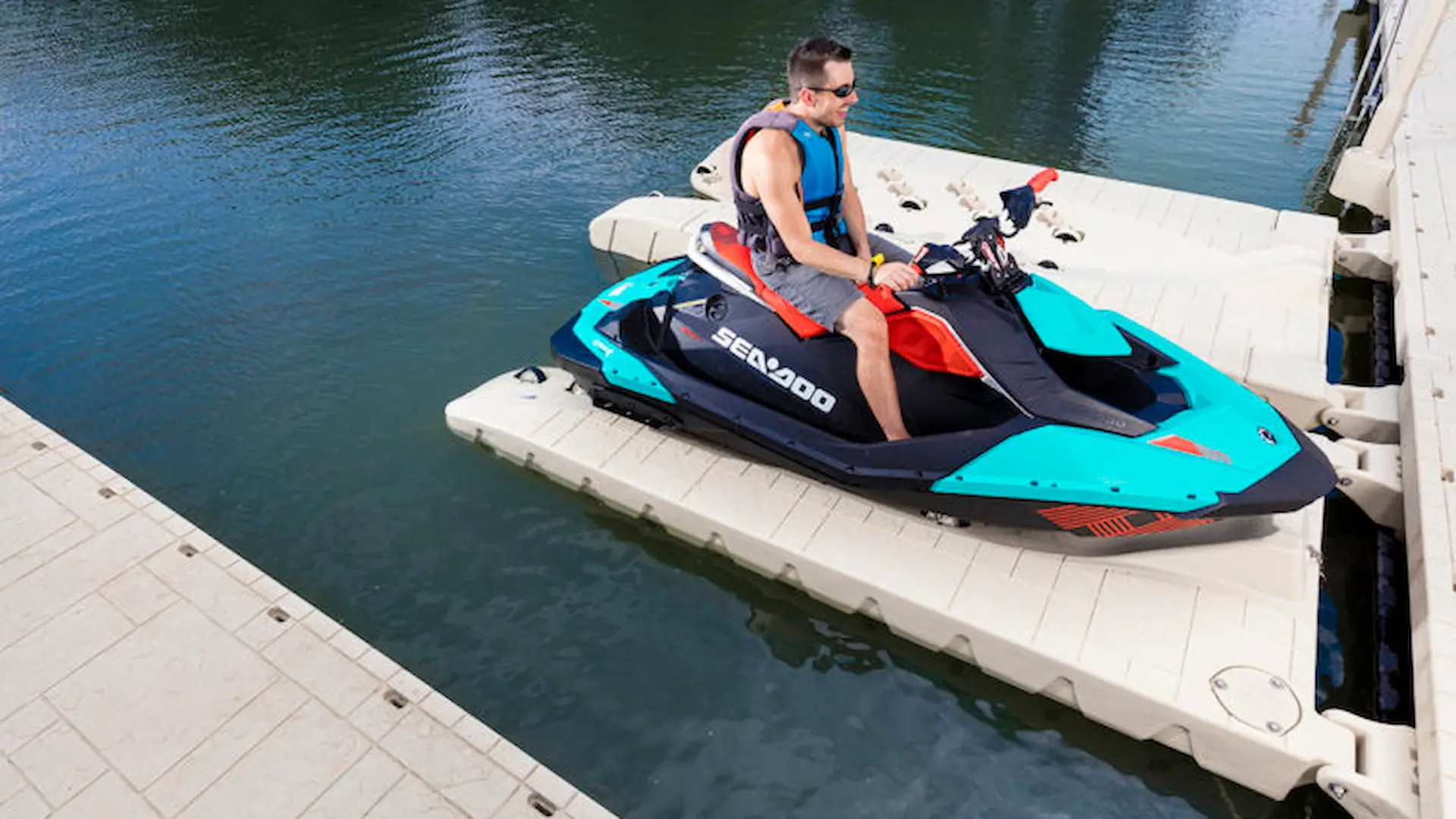 Man docking a Sea-Doo jet ski on a Wave Armor modular PWC port system.