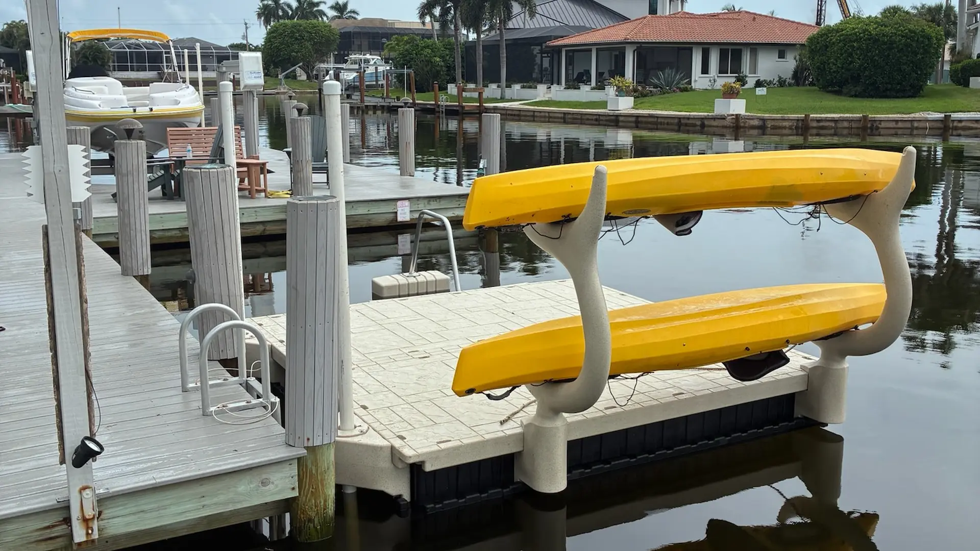 Wave Armor yellow kayak rack mounted on a waterfront dock in Florida.