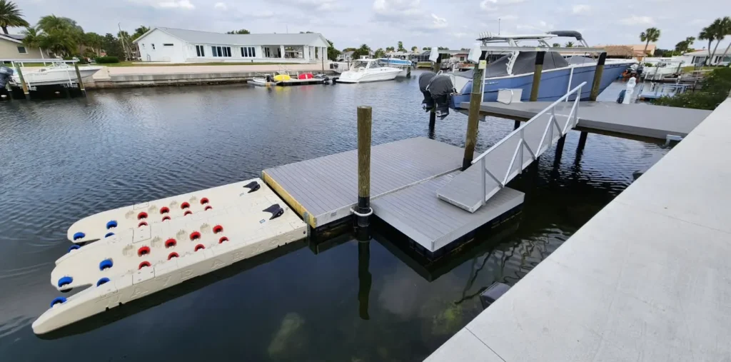 Ideal Dock Style: Tan Wave Armor single PWC port installed in a residential canal using side-mount pole connectors next to a floating dock.