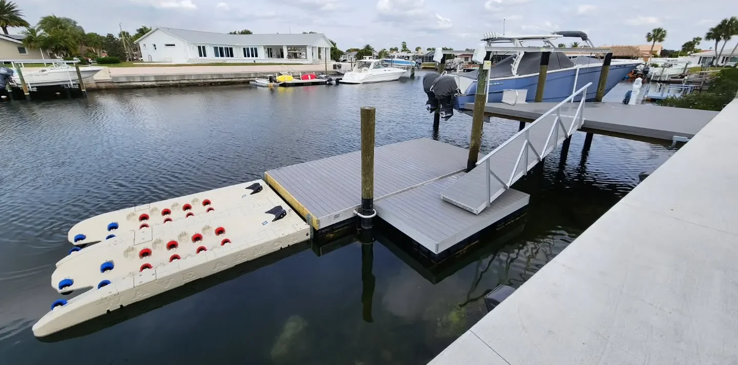 Best Jet Ski Dock: Tan Wave Armor single PWC port installed in a residential canal using side-mount pole connectors next to a floating dock.
