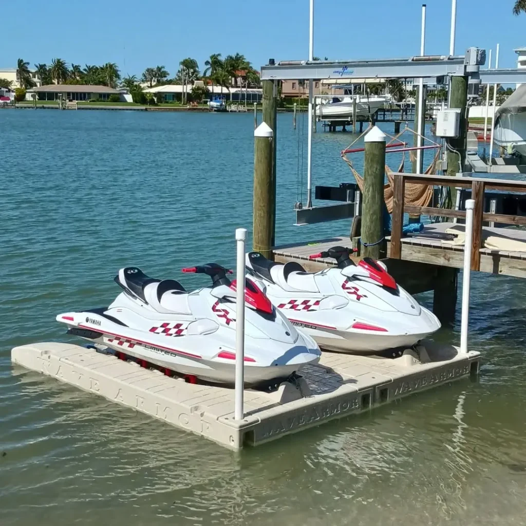 wave armor jet ski Dock: Performance Pair of white and red Yamaha VX Limited jet skis docked on Wave Armor PWC ports near a residential boat lift.