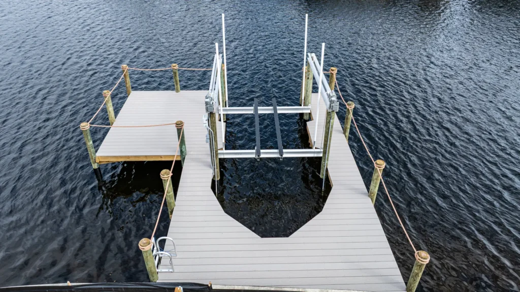 Aerial view of an aluminum boat lift and dock installation on a Florida waterfront property.