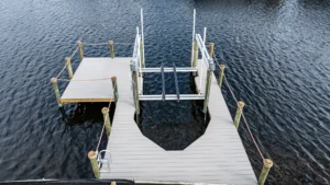 Aerial view of an aluminum boat lift and dock installation on a Florida waterfront property.