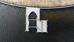 Overhead view of an aluminum boat lift installed on a curved seawall dock in Cape Coral, Florida.