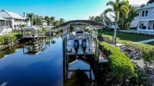 Front-facing view of a boat lift with canopy and dock system on a Cape Coral waterfront property.
