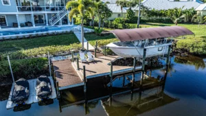 Boat lift with canopy and jet ski lifts installed on a residential Florida waterfront dock.