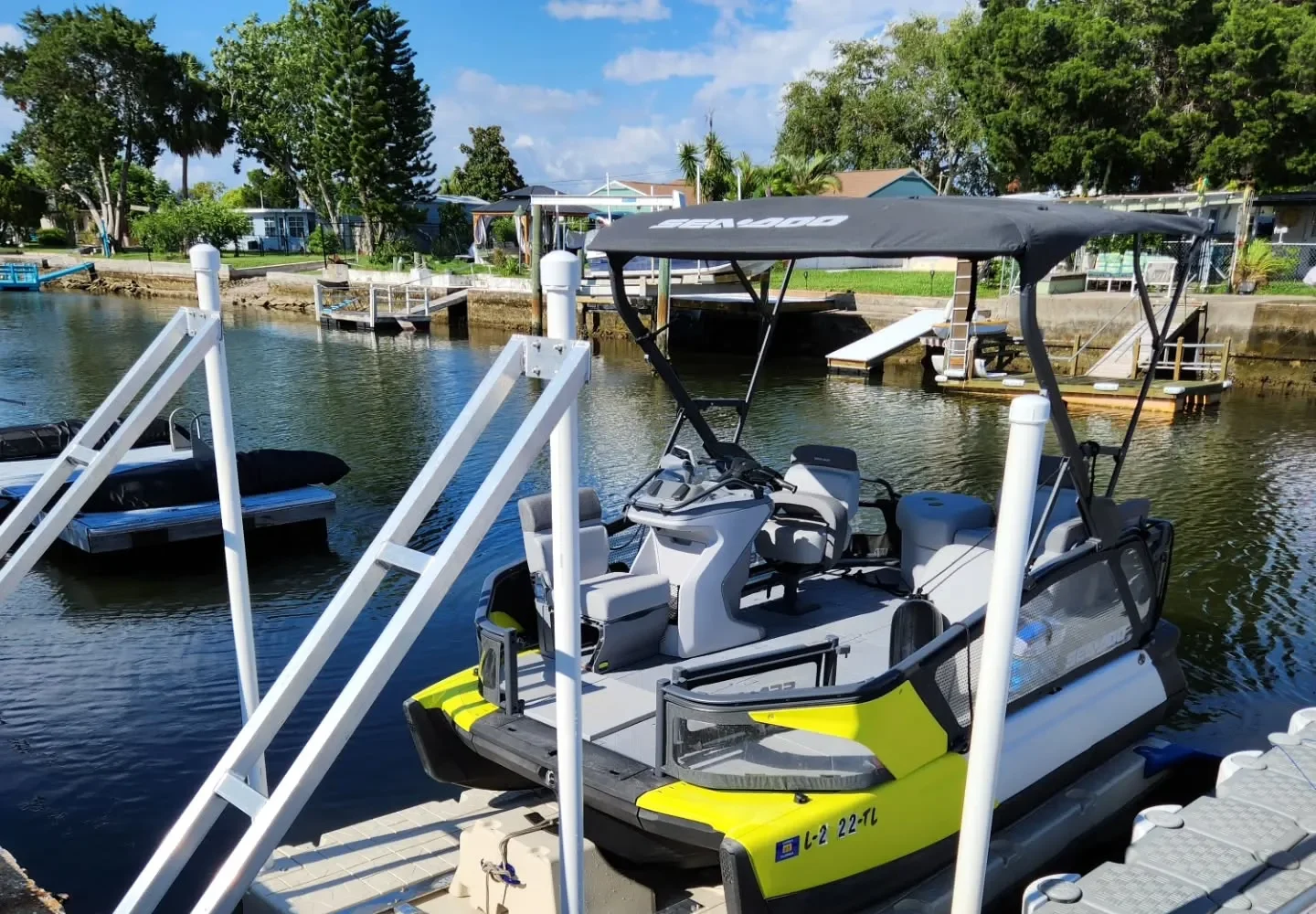 Dock Construction: black canopy on a specialized floating boat lift at a waterfront property.