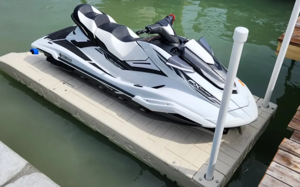 Best Jet Ski Dock: White Yamaha FX Cruiser Wave Runner parked on a Wave Armor Dock installer floating jet ski port at a residential dock.