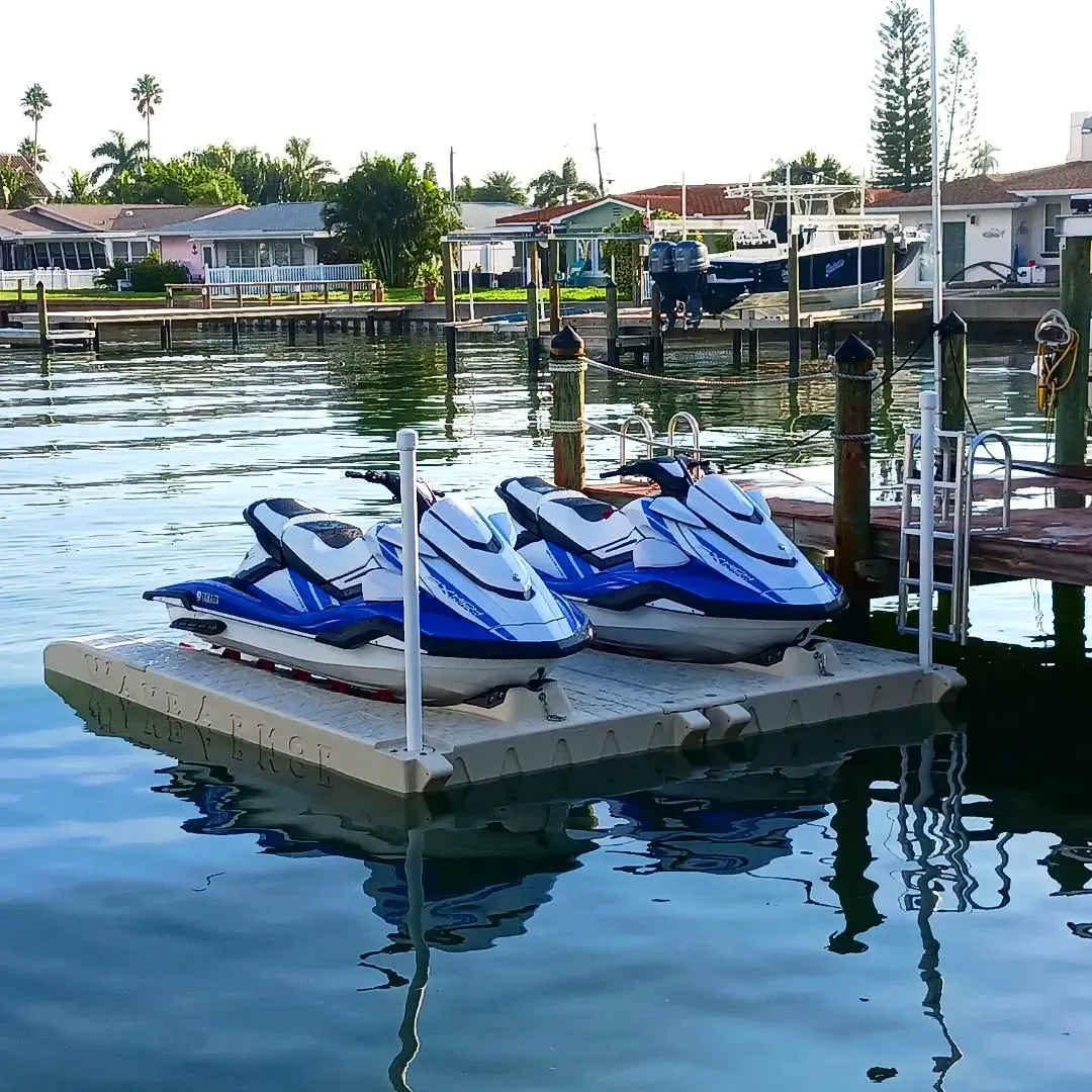 Best Jet Ski Docks: Pair of blue and white Yamaha WaveRunners parked on a dual Wave Armor floating port system in a saltwater canal.