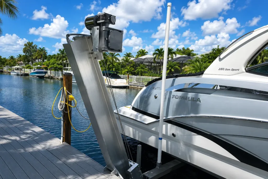 Heavy-duty aluminum boat lift showcasing high boat lift capacity supporting a Formula 350 boat at a tropical waterfront dock with calm canal water and palm trees in the background.