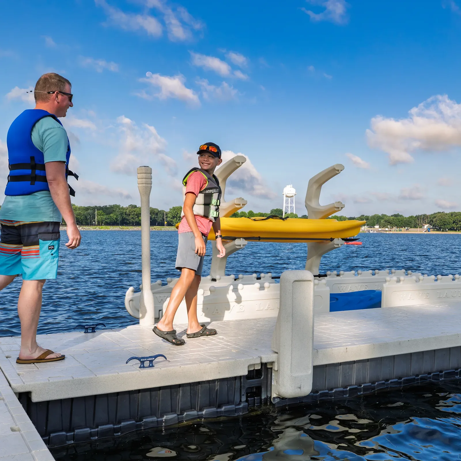 Kids launching kayaks from a Wave Armor Kayak Launch